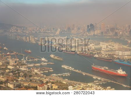 View From The Air Of Ships Docked At Harbor Against Cityscape Obscured By Dense Air Pollution Close 