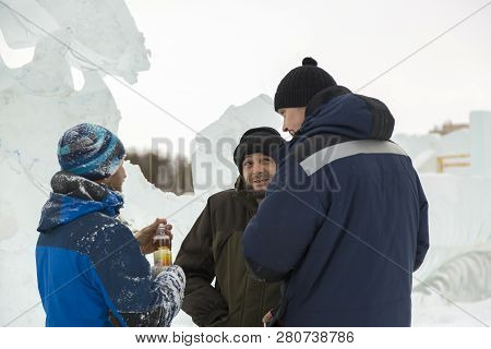Three Workers At The Installation Of The Ice Town