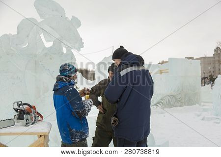Three Workers At The Installation Of The Ice Town