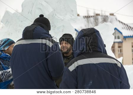 Three Workers At The Installation Of The Ice Town