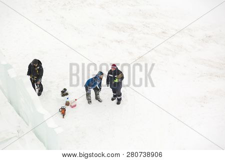Three Workers At The Installation Of The Ice Town