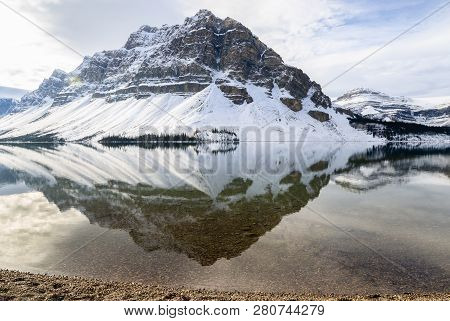 Scenic Winter View Of Bow Lake With Rocky Mountain Reflection In Banff National Park, Alberta, Canad