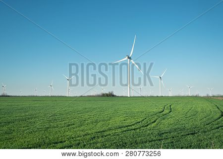 Wind Power Station On Field. Technology And Inovation. Green Energy Composition. Wind Turbines. Indu