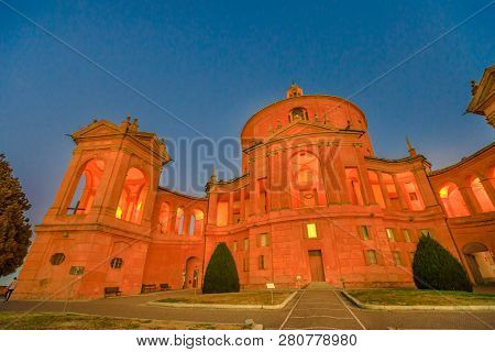 Courtyard Of The Sanctuary Of Madonna Di San Luca Illuminated At Blue Hour. Central Facade Of Basili