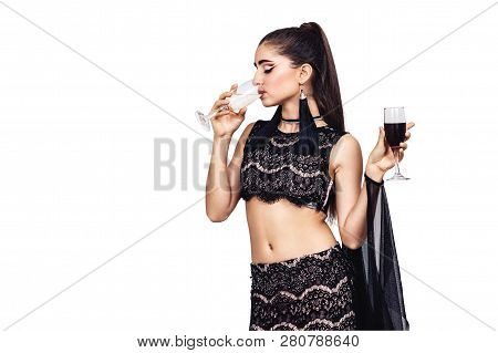 Young Gorgeous Girl Holds A Glass Of Wine And Drinks Champagne. Isolated On White