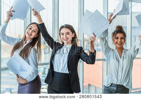 Three Young Beautiful Brunette Business Ladies In The Office. All Happy Dancing With