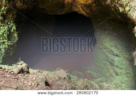 The Misty Entance To Jomblang Cave, Yogyakarta, Indonesia.
