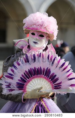 Venice, Ve, Italy - February 5, 2018: Masked Woman With Hand Fan At The Venice Carnival In Saint Mar