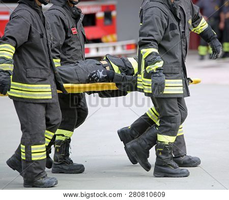 Vicenza, Vi, Italy - May 10, 2018: Four Italian Firefighters Transport An Injured On The Stretcher D