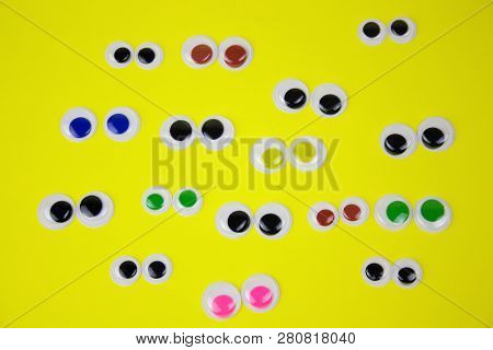 Googly Eyes On Yellow Pastel Background,top View Flat Lay