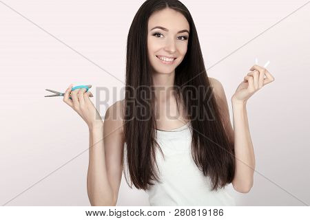 Stop Smoking Concept. Young Woman Cut Cigarettes With Scissors Happy Smiling. Focus On Hand, Scissor