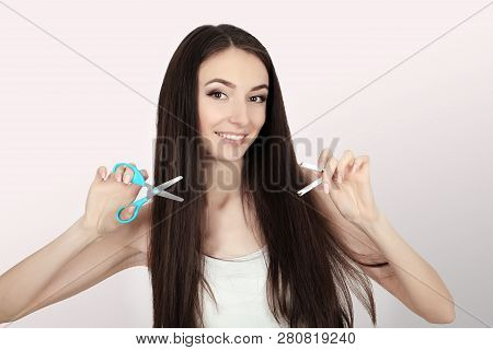 Stop Smoking Concept. Young Woman Cut Cigarettes With Scissors Happy Smiling. Focus On Hand, Scissor