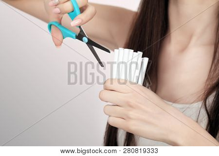 Stop Smoking Concept. Young Woman Cut Cigarettes With Scissors Happy Smiling. Focus On Hand, Scissor