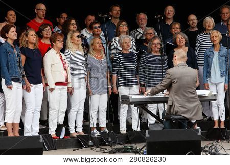 Strangnas, Sweden - May 20, 2017: The Singing Choir Lovsangarna Perform On An Outdoor Stage In The U