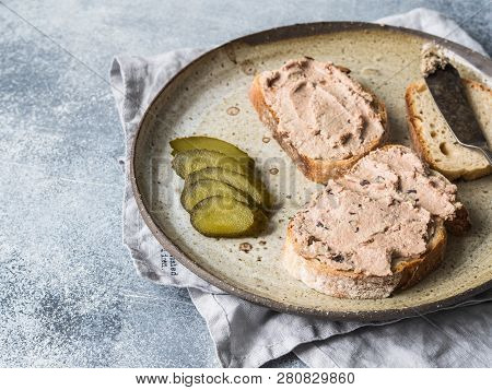 Two Toasts Duck With Prunes Rillettes Pate On White Bread With Pickled Cucumber Slices On Vintage Pl