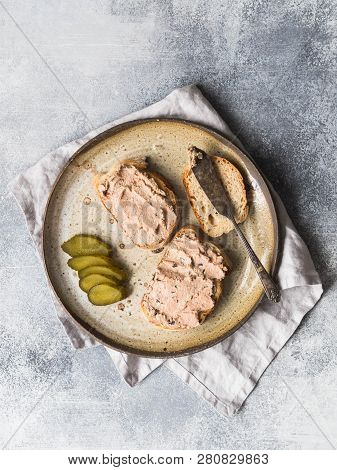 Two Toasts Duck With Prunes Rillettes Pate On White Bread With Pickled Cucumber Slices On Vintage Pl