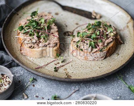 Two Toasts Duck With Prunes Rillettes Pate On White Bread With Sprouts And Various Seeds On A Vintag