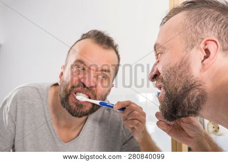 Funnny Guy Taking Care Of His Oral Hygiene, Brushing Teeth During Morning Bathroom Routine.