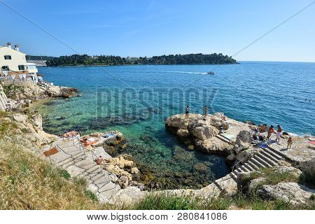Rovinj, Croatia - May 20, 2018: View On Rovinj Central Town Beach And Adriadic Sea In Bright Sunny S