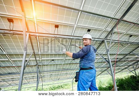 Young Electrician In Hard Hat And Rubber Gloves Wiring Solar Photo Voltaic Modules Inside The New In