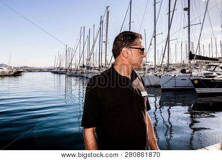 St. Tropez, France - 2019. Photographer Working In The Harbor Of St. Tropez, French Riviera.