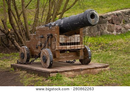 The Old Cast-iron Cannon On A Wooden Stand