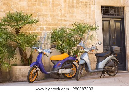 Bari, Italy - July 11,2018,  Typical Street Scene In Bari With A Two Old Scooter On An Old Narrow Co