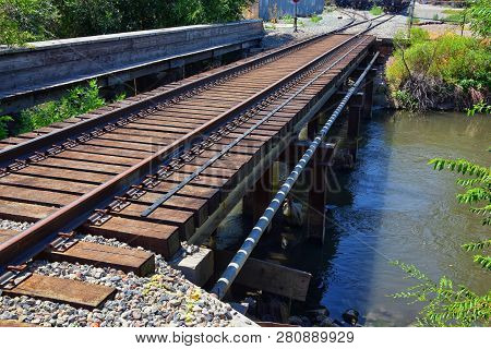 Views Of Jordan River Trail Pedestrian And Train Track Bridge With Surrounding Trees, Russian Olive,