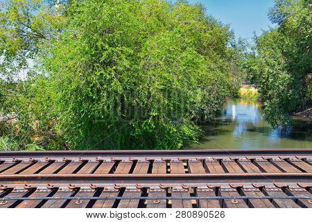 Views Of Jordan River Trail Pedestrian And Train Track Bridge With Surrounding Trees, Russian Olive,