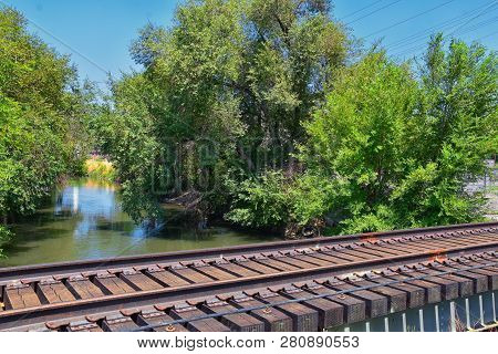 Views Of Jordan River Trail Pedestrian And Train Track Bridge With Surrounding Trees, Russian Olive,