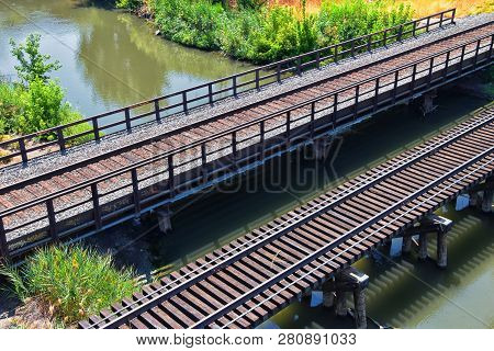 Views Of Jordan River Trail Pedestrian And Train Track Bridge With Surrounding Trees, Russian Olive,