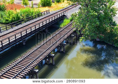 Views Of Jordan River Trail Pedestrian And Train Track Bridge With Surrounding Trees, Russian Olive,