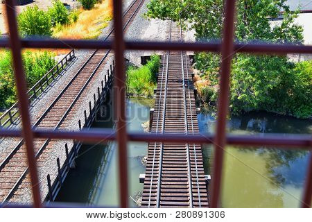 Views Of Jordan River Trail Pedestrian And Train Track Bridge With Surrounding Trees, Russian Olive,