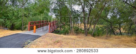 Views Of Jordan River Trail Pedestrian And Train Track Bridge With Surrounding Trees, Russian Olive,
