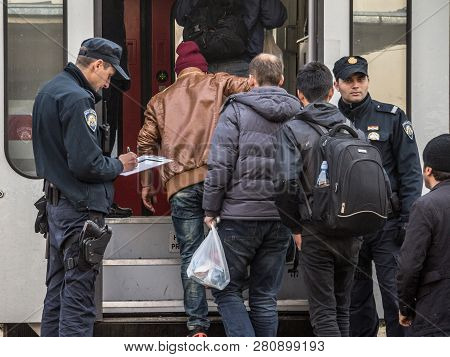 Sid, Serbia - November 14, 2015: Croatian Police Officers Checking Refugees, Boarding A Train To Cro