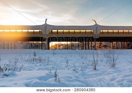 Elevated Highway Through The Winter Forest At Sunset