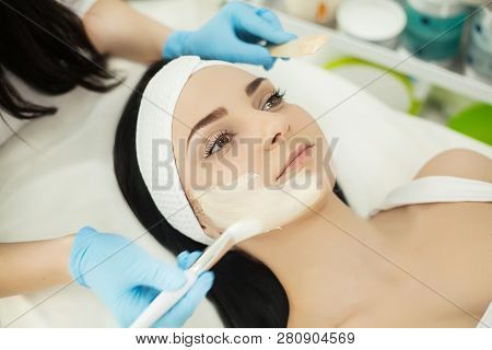 Girl At Spa Salon. Beautician Applying White Cosmetic Powder