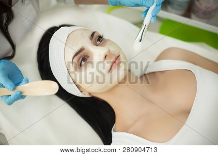 Girl At Spa Salon. Beautician Applying White Cosmetic Powder