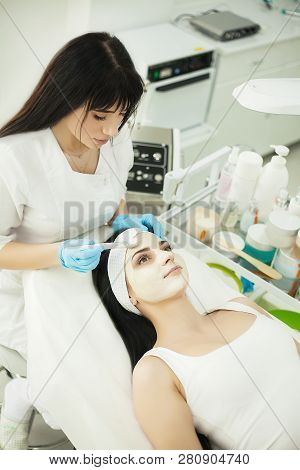 Girl At Spa Salon. Beautician Applying White Cosmetic Powder