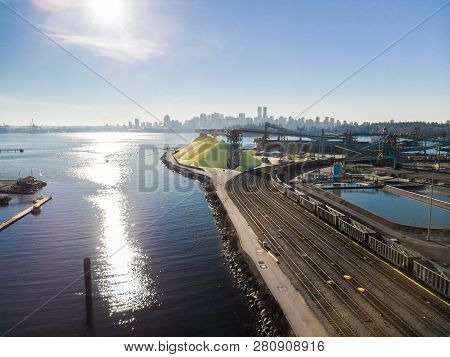 Aerial Shot Of A Line Of Cargo Train Cars In The North Vancouver Trainyard.