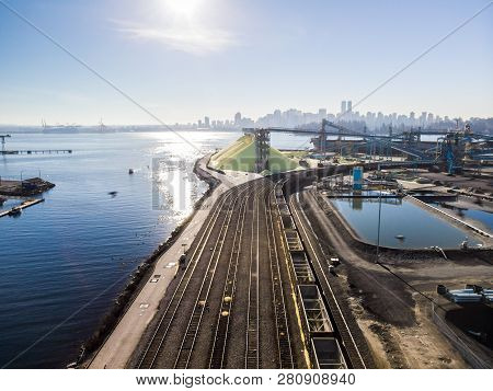 Aerial Shot Of A Line Of Cargo Train Cars In The North Vancouver Trainyard.