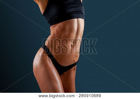 Beautiful Super Fit Young Woman Showing Off Her Perfect Muscular Ripped Abs. Fitness Model. Perfect 