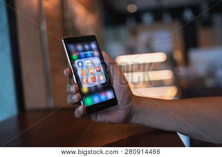 Chiang Mai, Thailand - June 09,2018: Man Holding Huawei With Icons Of E-commerce And Online Shopping