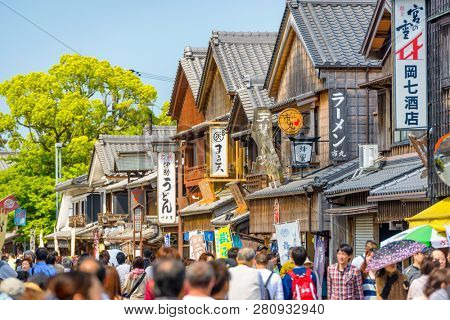ISE, JAPAN - APRIL 25, 2014: Crowds walk on the historic shopping street of Oharai-machi. The reconstructed buildings are completed in the Edo period traditional style.