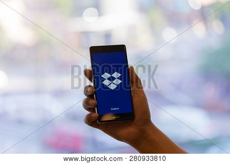 Chiang Mai, Thailand - Oct. 28,2018: Man Holding Huawei With Dropbox On Screen. Dropbox Is A Service