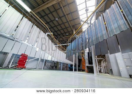 Powder Coating Line. Metal Panels Are Suspended On An Overhead Conveyor Line. Painting Products In A