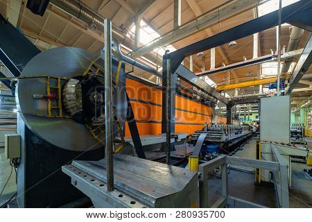 Cold Rolled Steel Coil On Decoiler Of Machine In Metalwork Manufacturing. Modern Equipment For Sheet