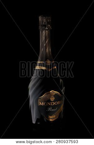 Bottle of brut sparkling wine Mondoro Brut  isolated on a black background.