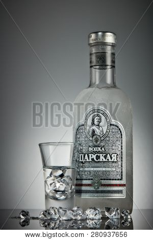 St.Petersburg, Russia - December 2018 - Bottle of cold vodka Czar's with ices and shot glass on a grey background with reflection. Premium vodka.  Produced in Russia. Original russian recipe