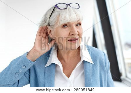 Close Up Elegant Stylish Elderly Woman In Formal Suit Having Hearing Problems, Holding Hand At Her E